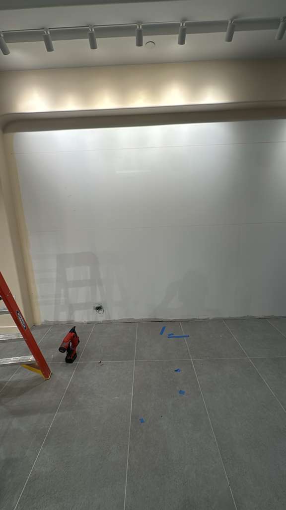 Empty wall recess surveyed before installation begins.