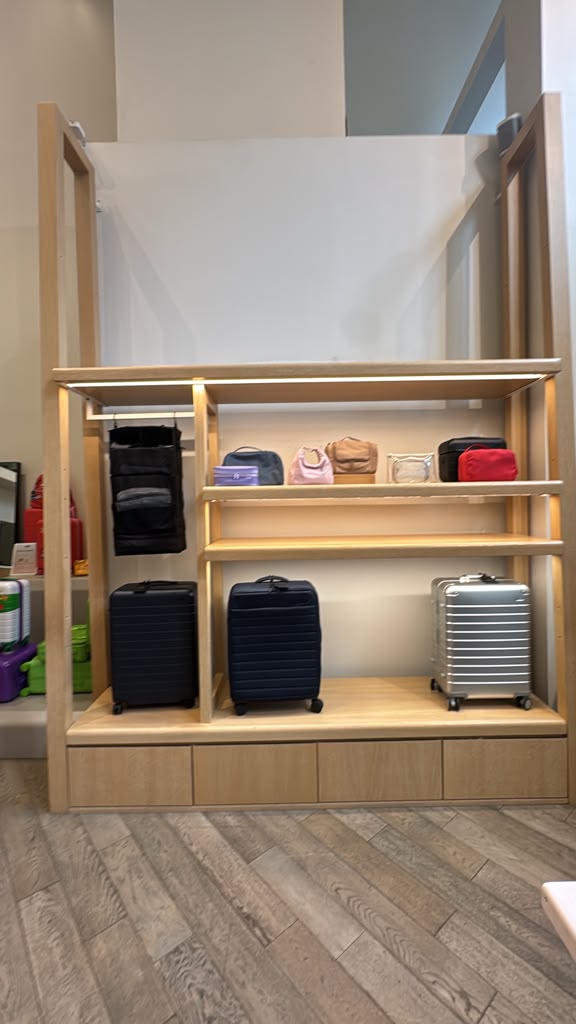Timber shelving unit with integrated lighting and open display levels.
