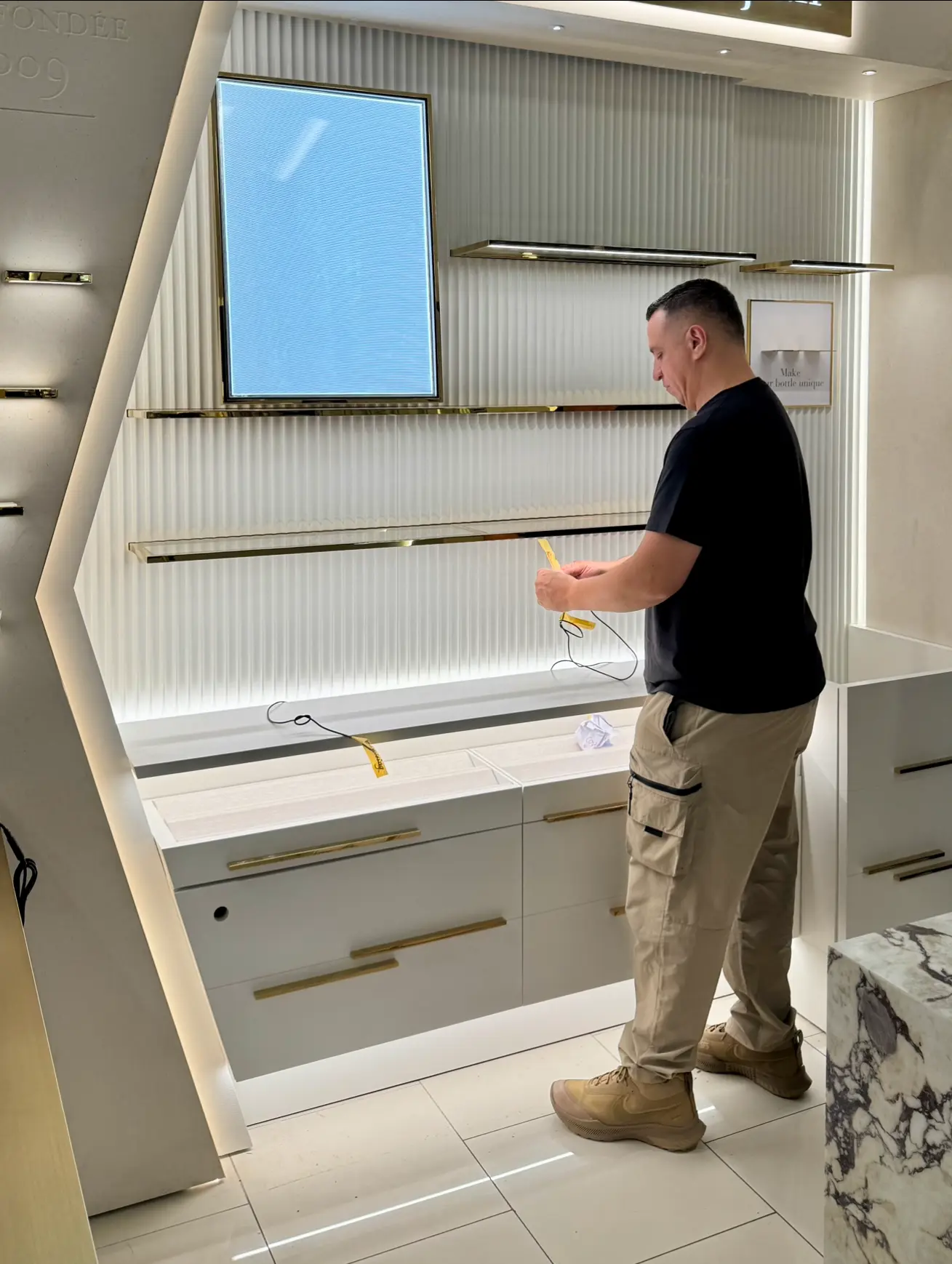 Installer checking display shelving inside a boutique retail space