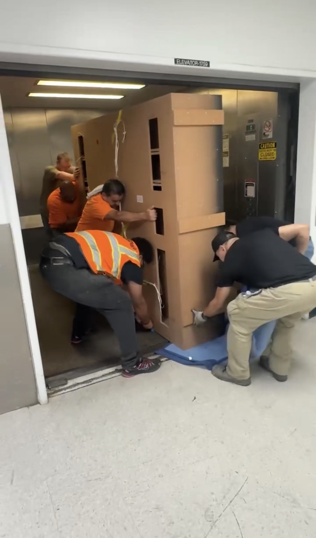 Protected movement of a large-format fixture during on-site installation.