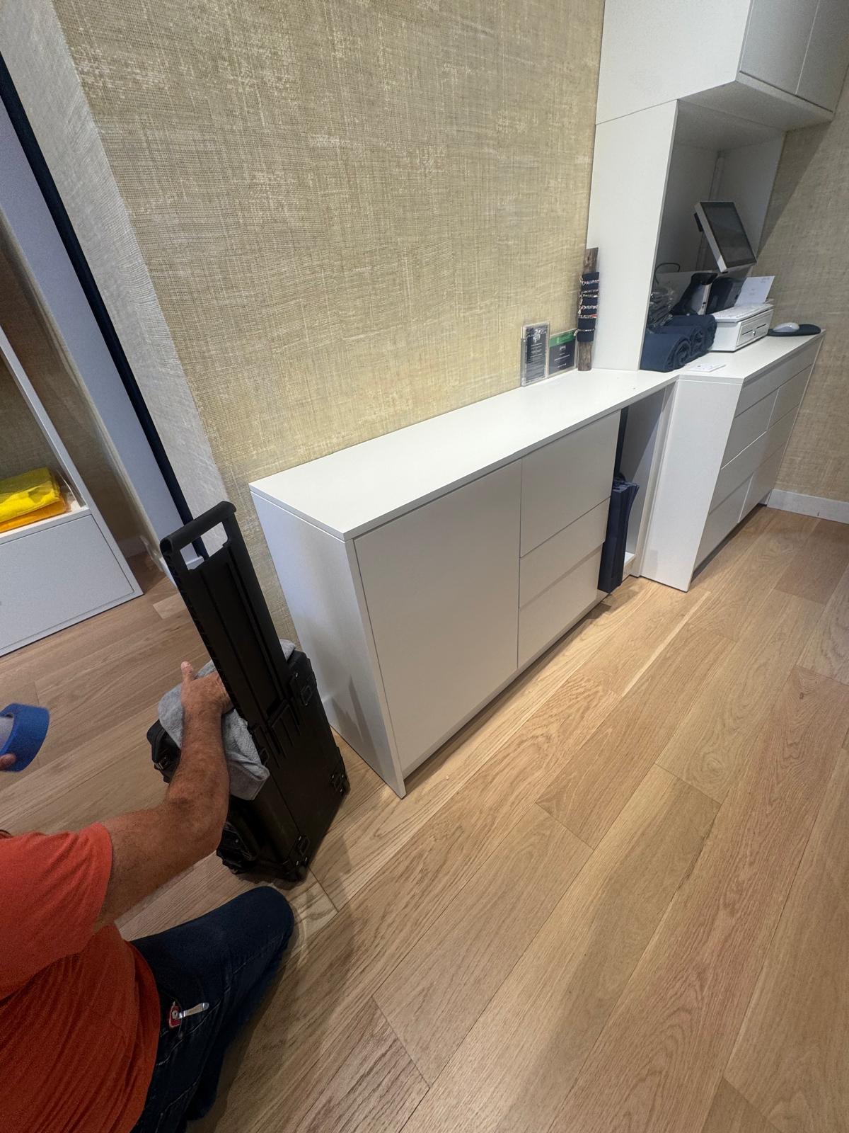 Installation in progress alongside the completed white cabinetry run.